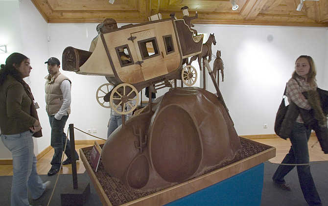 People look at a chocolate scuplture in Obidos village 80km north of Lisbon during the Chocolate Festival, Portugal.