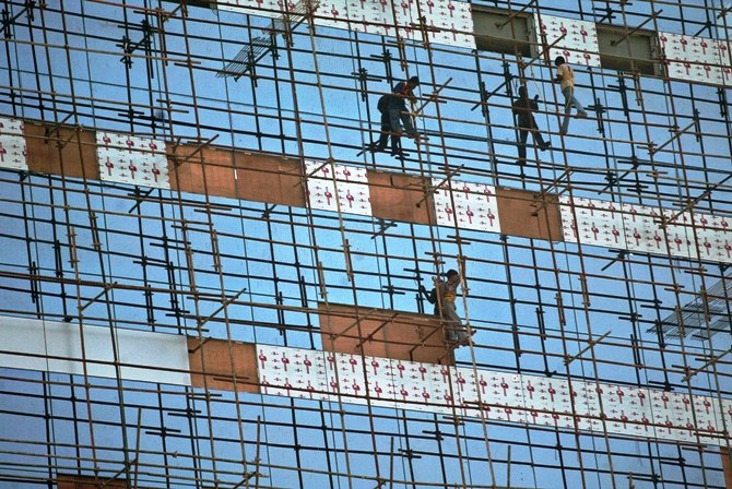 This file photograph shows Indian workers build an information and technology park in Kolkata.