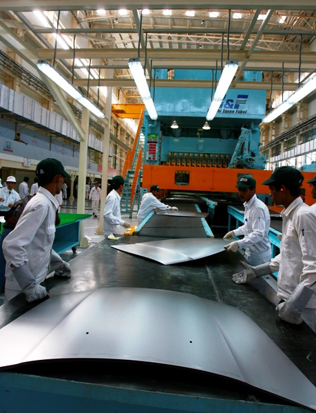 Employees work inside a new plant of Honda Siel Cars India Ltd.