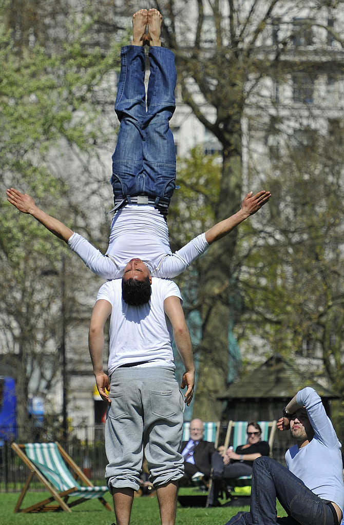 Park-goers practice gymnastic moves in Hyde Park in central London, United Kingdom.