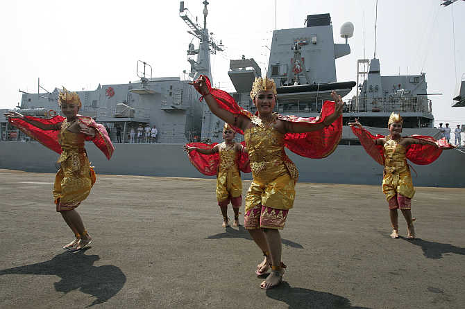 Dancers welcome the UK Royal Navy personnel of HMS Kent, docked in Tanjung Priok harbour, in Jakarta, Indonesia.