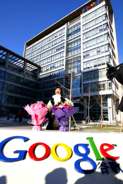 A Chinese Google user stands with bouquets of flowers that he wants to present to the Google China headquarters in Beijing.