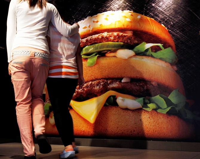 Customers walk up the stairs to a McDonald's outlet, the first one which opened in China in 1990, at the southern Chinese city of Shenzhen neighbouring Hong Kong.