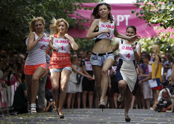 Women compete in a race in high heels in central Moscow, Russia.