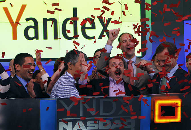 Founder and CEO Arkady Volozh, front, second right, celebrates as Yandex is listed on the Nasdaq exchange New York.