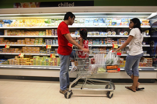 People shop in the chilled foods section of a Reliance Fresh supermarket in Mumbai.