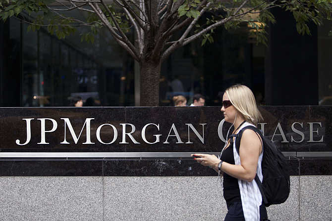 A woman walks past JPMorgan Chase's international headquarters on Park Avenue in New York.