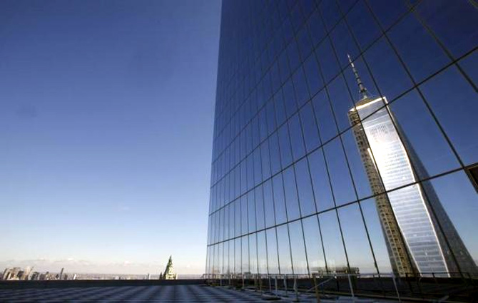 A reflection of the One World Trade Center tower is seen from a terrace on the 57th floor of the soon to be opened 4 World Trade Center tower in New York.