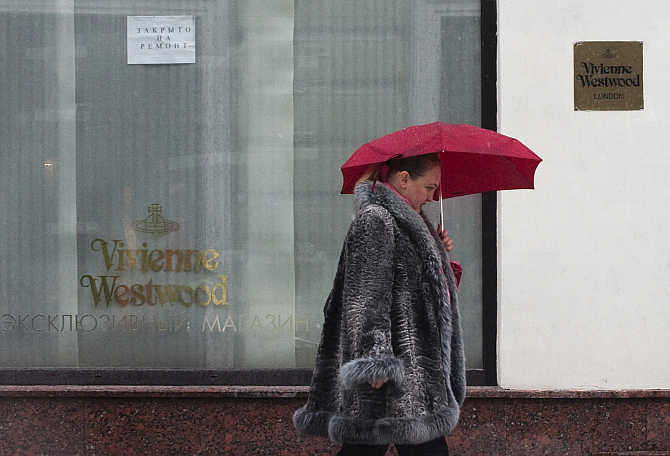 A woman walks past a Vivienne Westwood boutique in Moscow, Russia.
