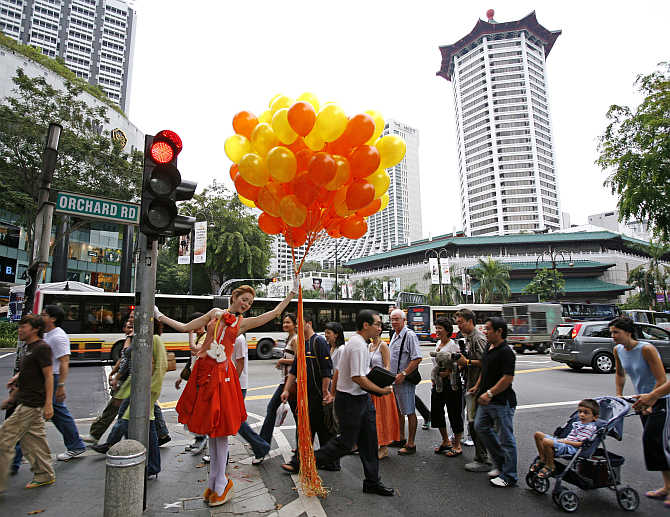 British model Lily Cole poses at a traffic intersection during a photo shoot on Orchard Road in Singapore.