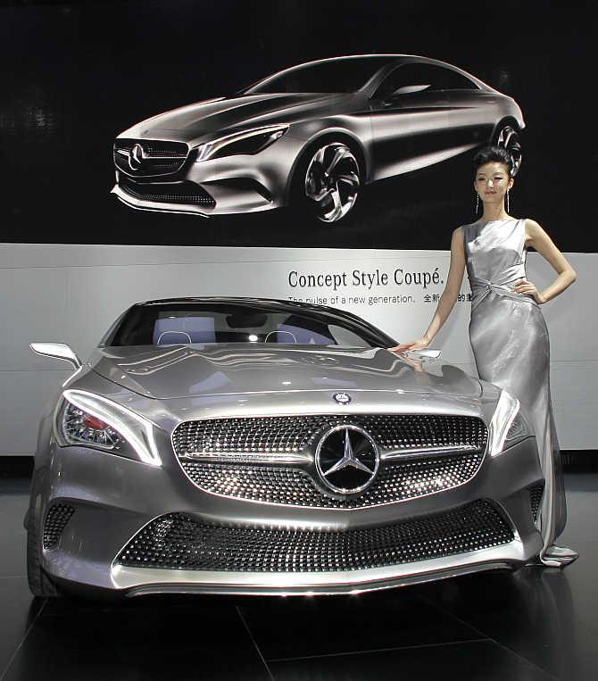 A model stands next to a Mercedes-Benz Concept Style Coupe in Beijing, China.