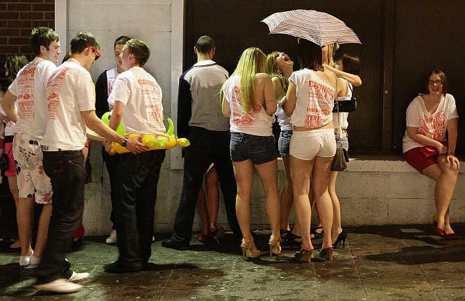 Revellers queue to enter a night club in Lincoln, eastern England.