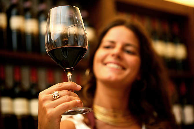 Federica Bon checks a glass of wine in the cellar of the Arnaldo Caprai vineyard near Montefalco, Italy.