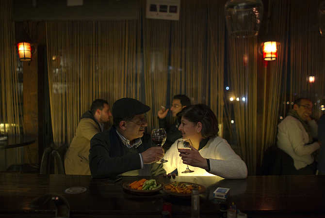 A Palestinian couple sits at the bar of a restaurant in the West Bank city of Ramallah.