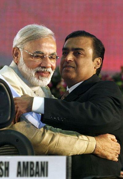 Gujarat's chief minister Narendra Modi (L) embraces Mukesh Ambani, chairman, Reliance Industries.