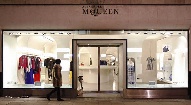 A pedestrian walks past British fashion designer Alexander McQueen's shop on Old Bond Street, in London, United Kingdom.