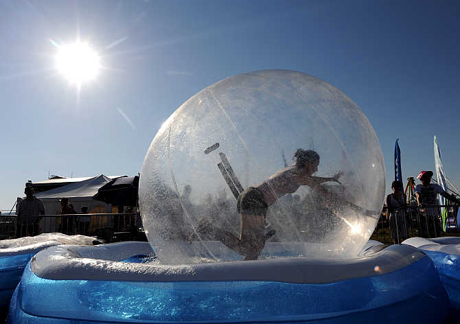 A reveller runs in a water ball during the Pohoda music festival at Trencin airport, 130km north of Bratislava, Slovakia.