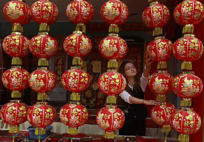 A shopkeeper arranges Chinese New Year decorations in Tainan, southern Taiwan.