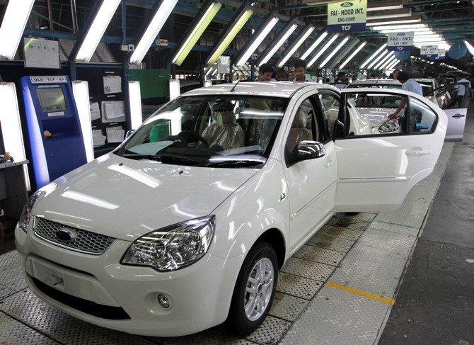 Workers make final inspections on Figo cars lined up at the assembly line at a plant of Ford India in Chengalpattu in Chennai.