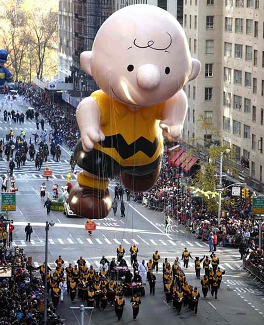 A Charlie Brown balloon floats make their way down 6th Ave during the Macy's Thanksgiving Day Parade in New York.