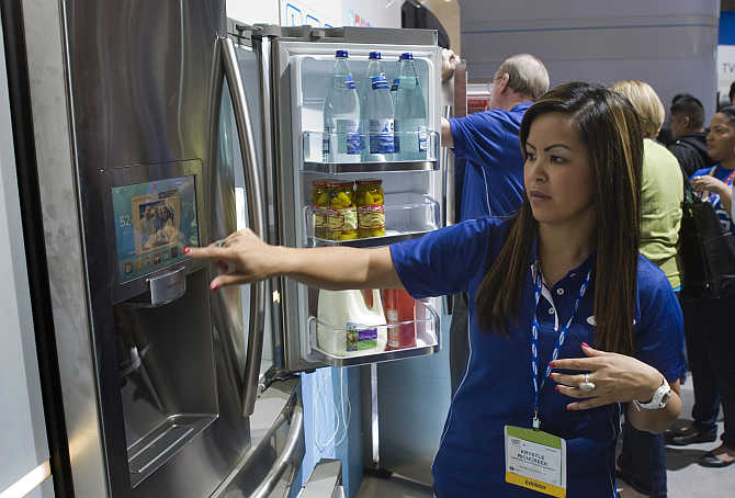 Samsung's Krystle Richcreek demonstrates a prototype Internet-enabled refrigerator with a 10.2 inch screen in Las Vegas, Nevada. The refrigerator, which connects to the Internet via Wi-Fi, has a variety of apps, including a grocery inventory manager and a Twitter feed.