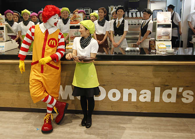 McDonald's 'Ronald McDonald' character chats with a counter staff in Tokyo, Japan.