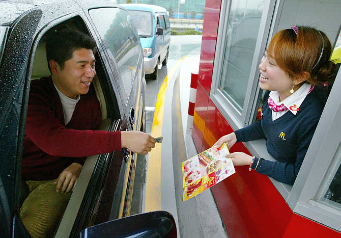 A customer buys food from McDonald's drive-thru in Shanghai, China.