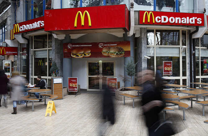 People walk in front of a McDonald's restaurant in Bucharest, Romania.