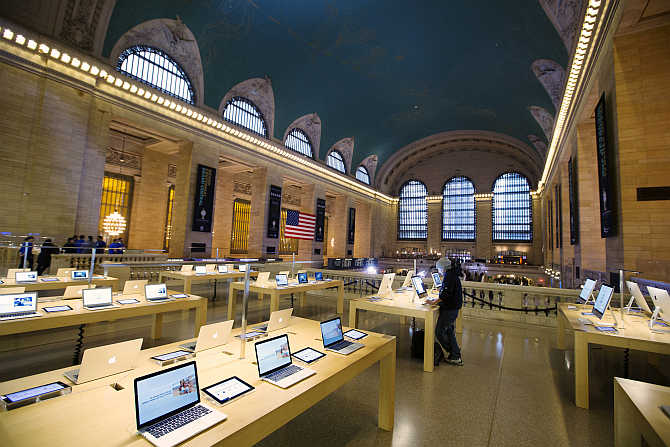 A man uses a computer at an Apple store inside Grand Central Station in New York City.