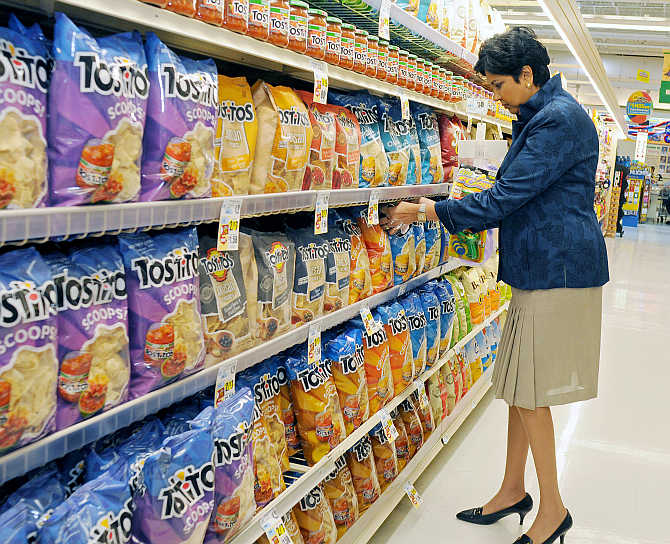 PepsiCo CEO Indra Nooyi checks products at the Tops SuperMarket in Batavia, New York.