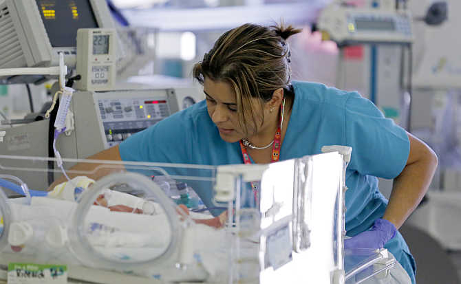 A nurse attends to an infant in the neonatal intensive care unit of the Holtz Children's Hospital at Jackson Memorial Hospital in Miami, Florida.