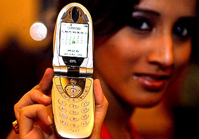 A model poses with mobile phone at a launch in Kolkata.