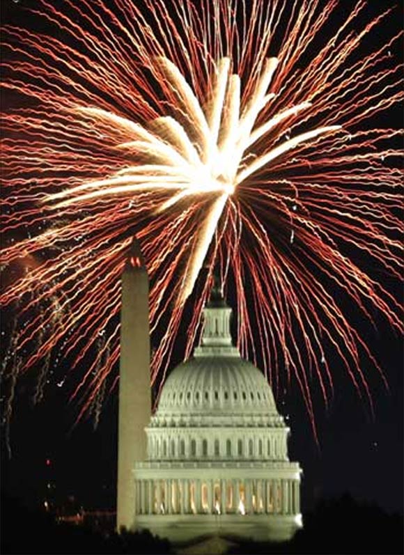 Fireworks explode over the United States Capitol dome and Washington Monument on Independence Day.