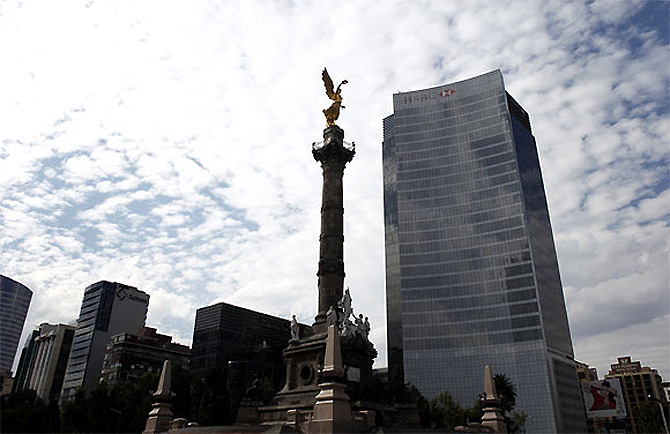 The Angel of Independence is seen near a building of HSBC in Mexico City.