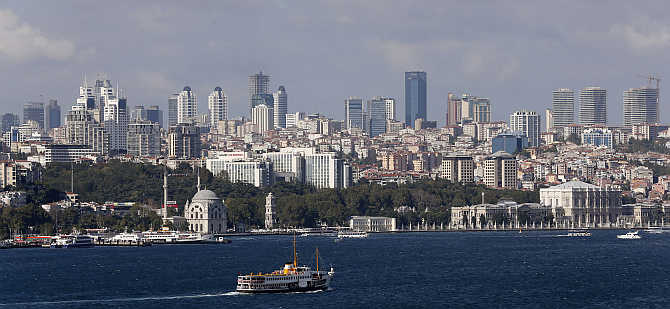 A ferryboat moves along the Bosphorus and past the city's skyscrapers in Istanbul, Turkey.