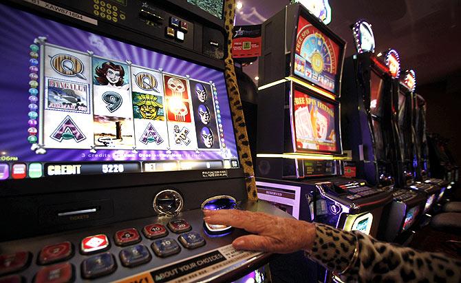 Anna Robinson plays at The Phantom slot machine at Bowlers Club in Central Sydney.