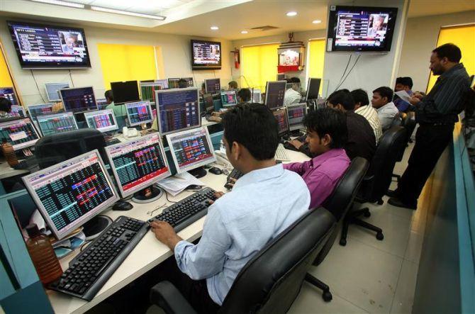 Stock brokers trade in a brokerage firm in Kolkata.