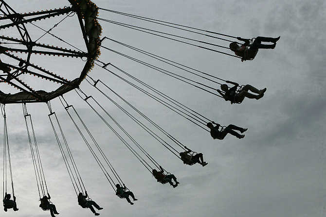 People ride a wave swinger at a carnival in Manila, the Philippines.