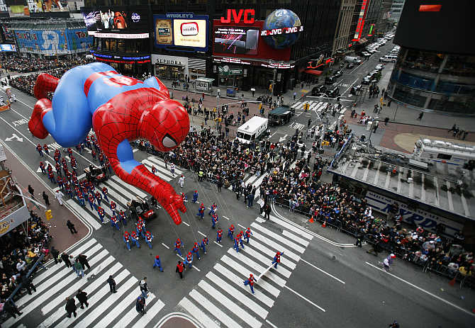 A Spiderman balloon passes through Times Square during the Macy's Thanksgiving Day parade in New York City, United States.