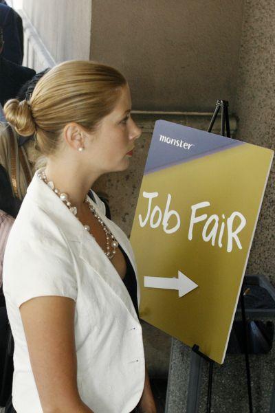 A candidate waits in the line to enter a job fair.