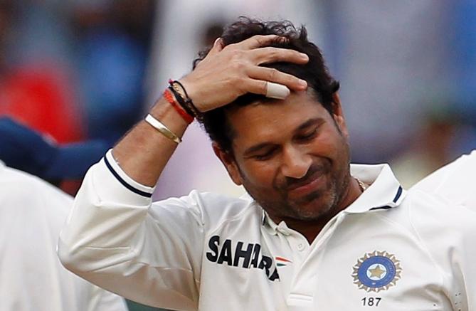 Sachin Tendulkar gestures as he prepares to bowl.