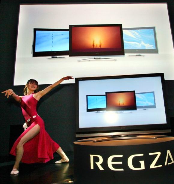 A model perform next to a flat-panel TV Regza at Japan's biggest technology trade show CEATEC.