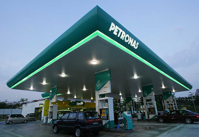 Motorists pump petrol at a Petronas station in Putrajaya outside Kuala Lumpur, Malaysia.