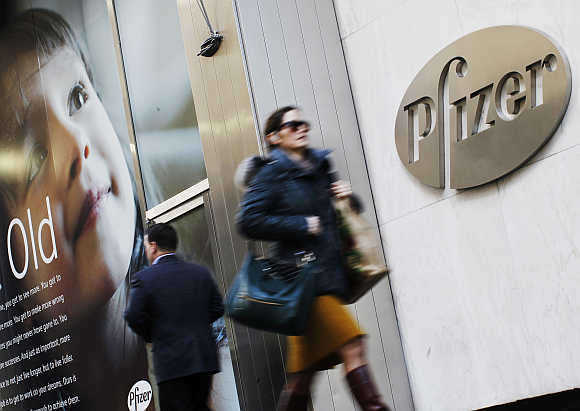 People walk past the Pfizer's headquarters in New York City.