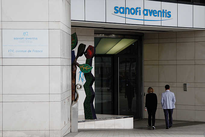 Employees enter Sanofi-Aventis headquarters in Paris, France.