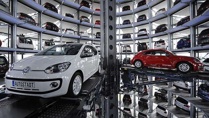 A Volkswagen Beetle, right, and an UP!, left, in a delivery tower at the company's headquarter in Wolfsburg, Germany.
