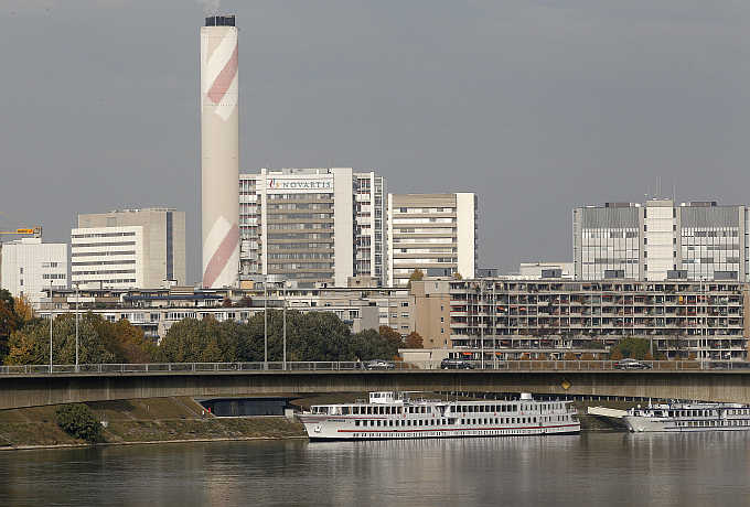 A view of the headquarters of Swiss drugmaker Novartis behind apartment buildings on the borders of the Rhine River in Basel.
