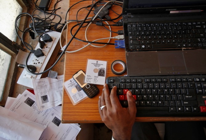 An operator works on his table while enrolling villagers for the Unique Identification (UID) database system at an enrolment centre at Merta district, Rajasthan.