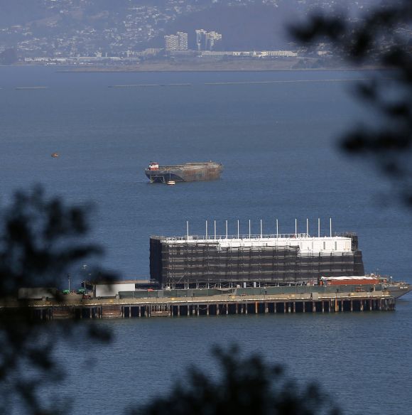 A barge built with four levels of shipping containers is seen at Pier 1 at Treasure Island in San Francisco, California.