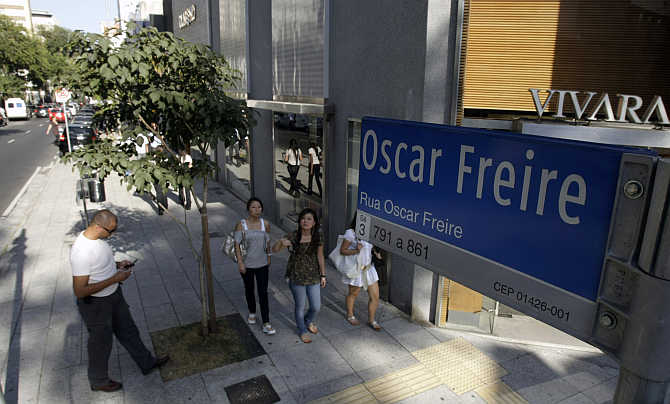 People walk along Oscar Freire street, Sao Paulo's version of Rodeo Drive in Beverly Hills, in Sao Paulo, Brazil.